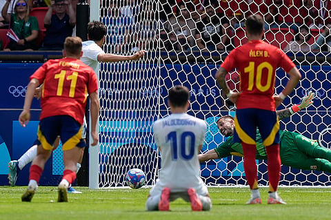 Spain's goalkeeper fails to stop a penalty 